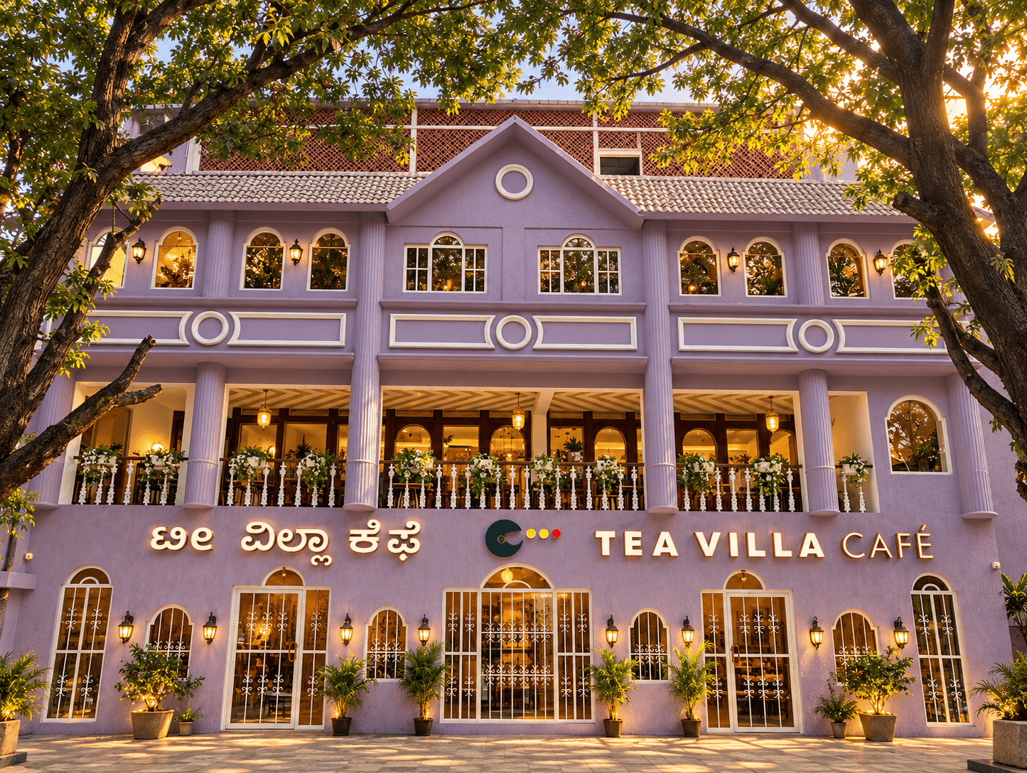 The lavender exterior of Tea Villa Cafe Jayanagar beneath large trees